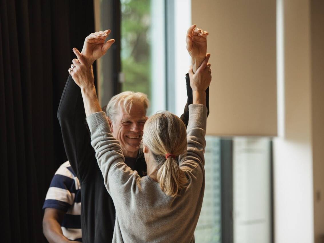 man and woman with hands over head | Collective Identity