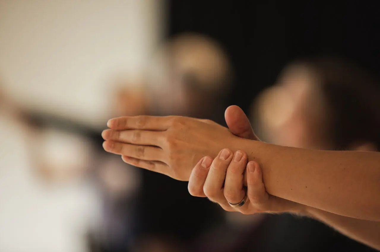 Woman holding arm | Collective Identity